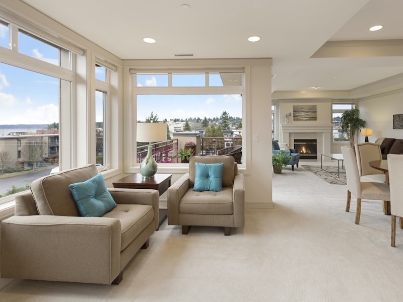 A calm living room with a beige couch and armchair